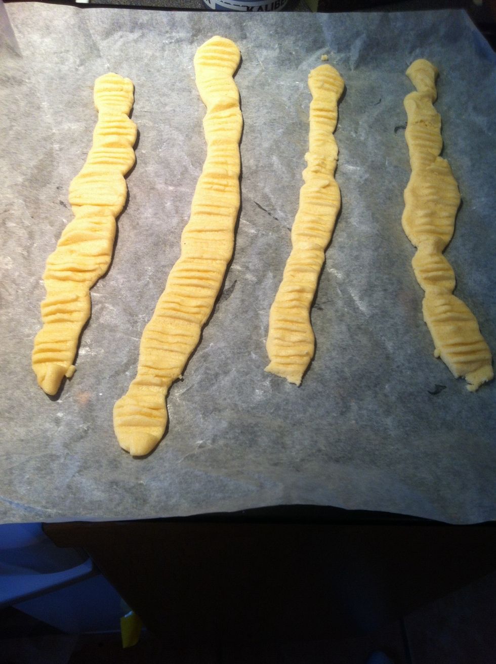 Put on A plats and form to rolls, then Flatten them With A fork