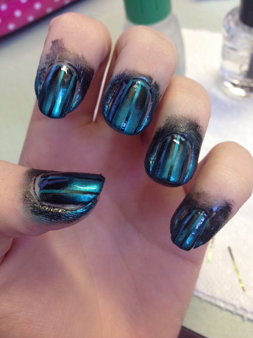 Put on a topcoat to smooth things out a bit and clean up around the nails with a qtip soaked in nail polish remover.