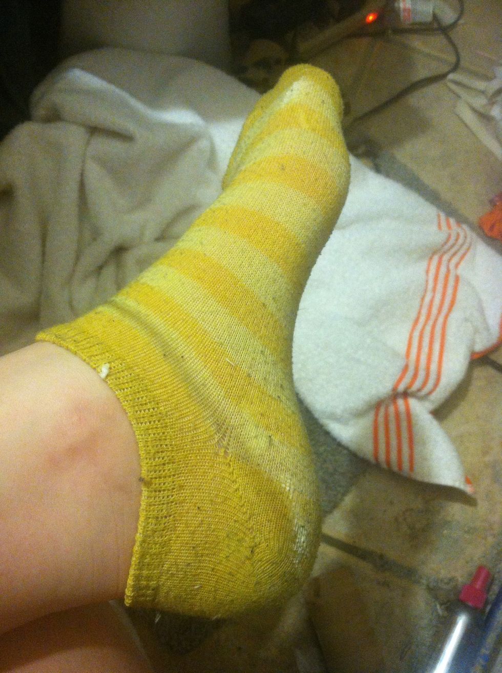 Put on socks to keep the lotion on and prevent it from getting on your bed or whatever.