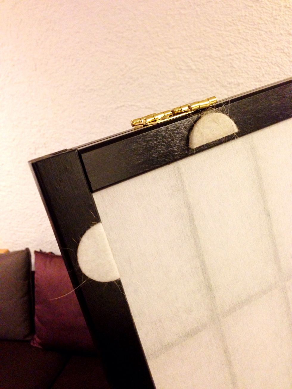Put on the felt pads on one side of one of the panels.