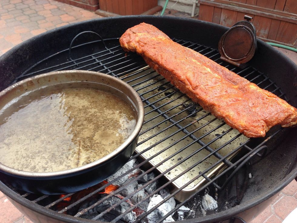 Put on the grate. Place a 2nd aluminum pan, half full with water, directly over the coals. Arrange the ribs over the drip pan as far from the actual fire as possible.