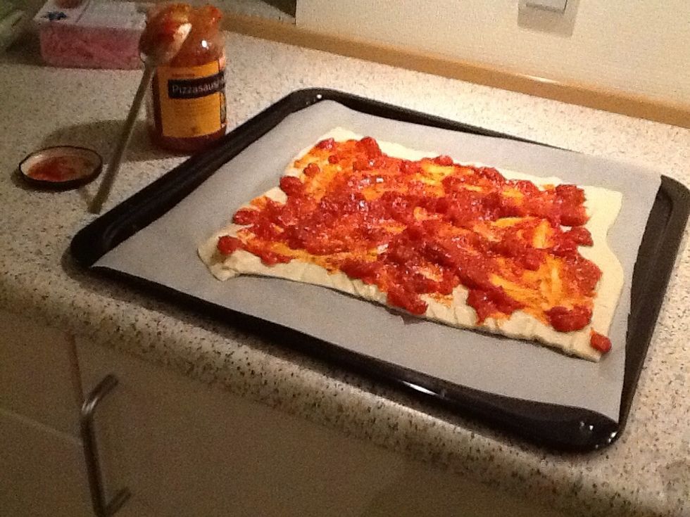 Put on the pizza sauce.