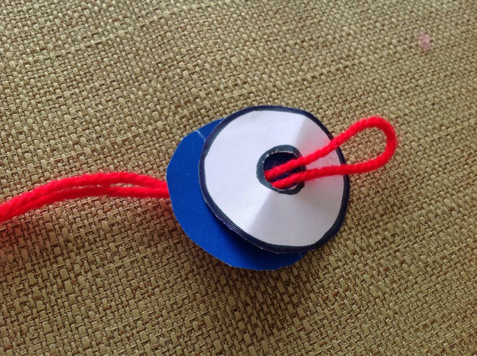 Put one folded string through the circles.