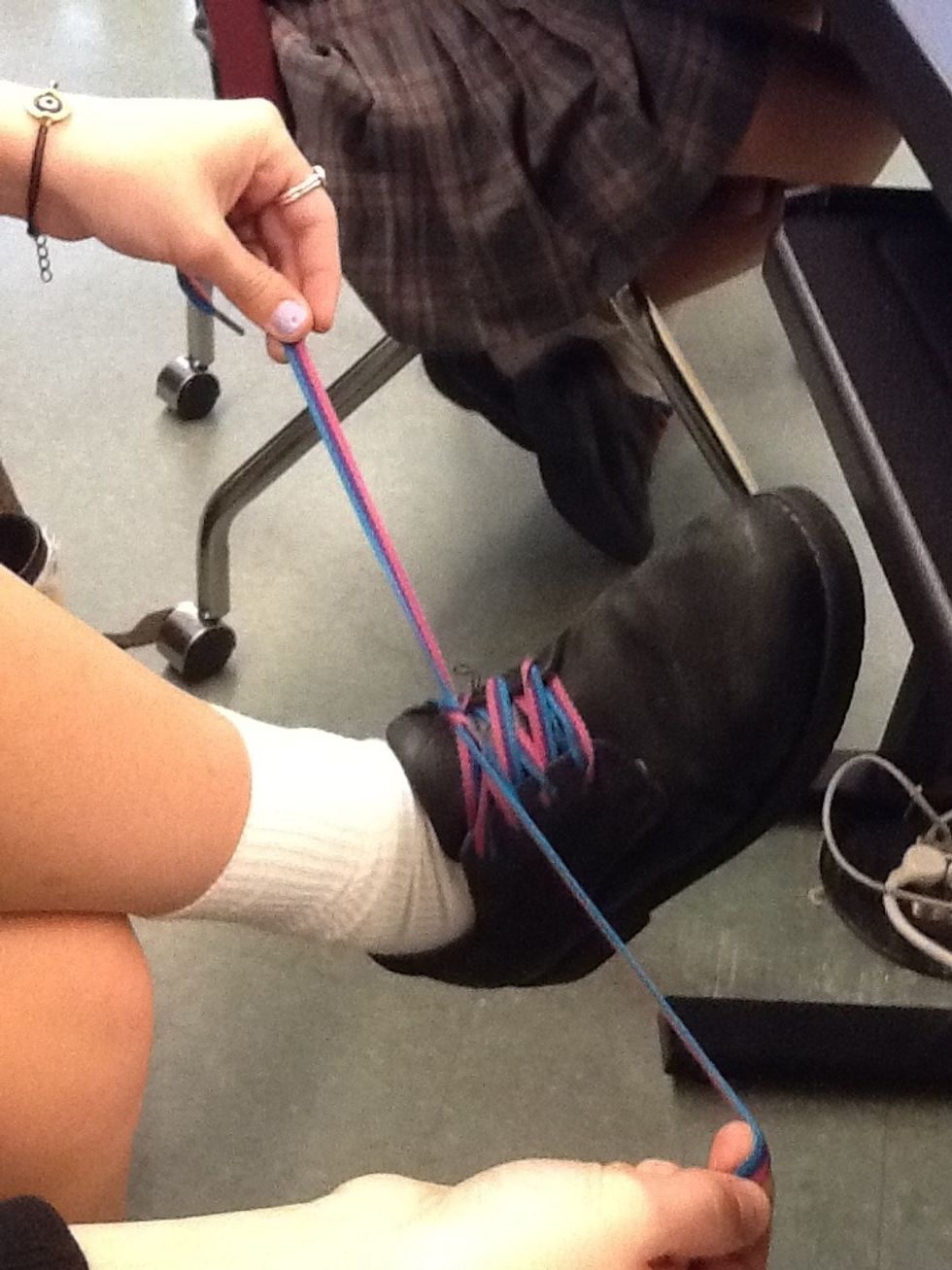 Put one lace under the another and tighten