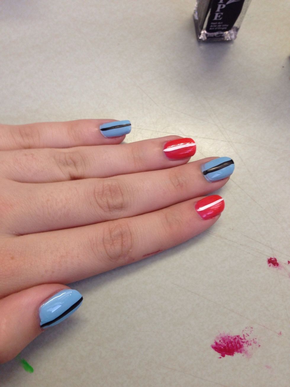 Put one line of a certain color down the center. I did black center with blue and white center with orange, then kept the pattern for each nail.