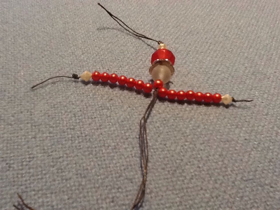 Put one of the body strings over and one under