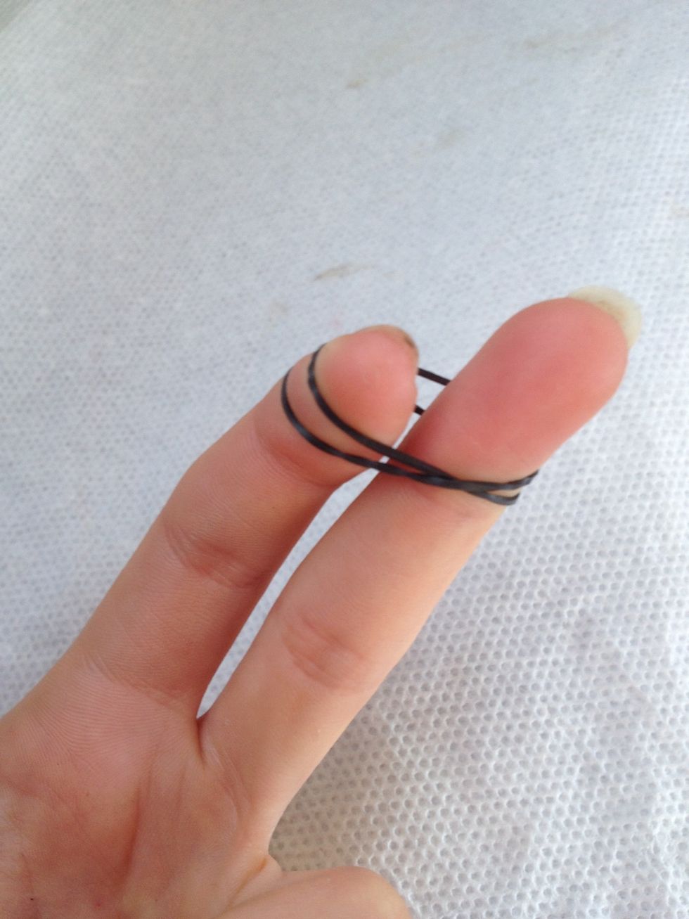 Put one of the loops on top of the other loop to create a double O.