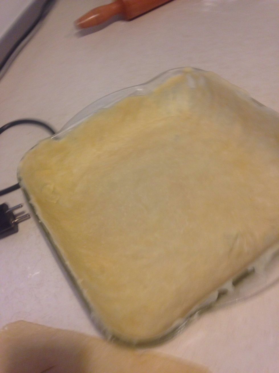 Put one of your rolled dough into the dish. TIP: if you find the dough is going to rip, roll the dough loosely around your rolling pin. Then unroll the pastry over the dish.