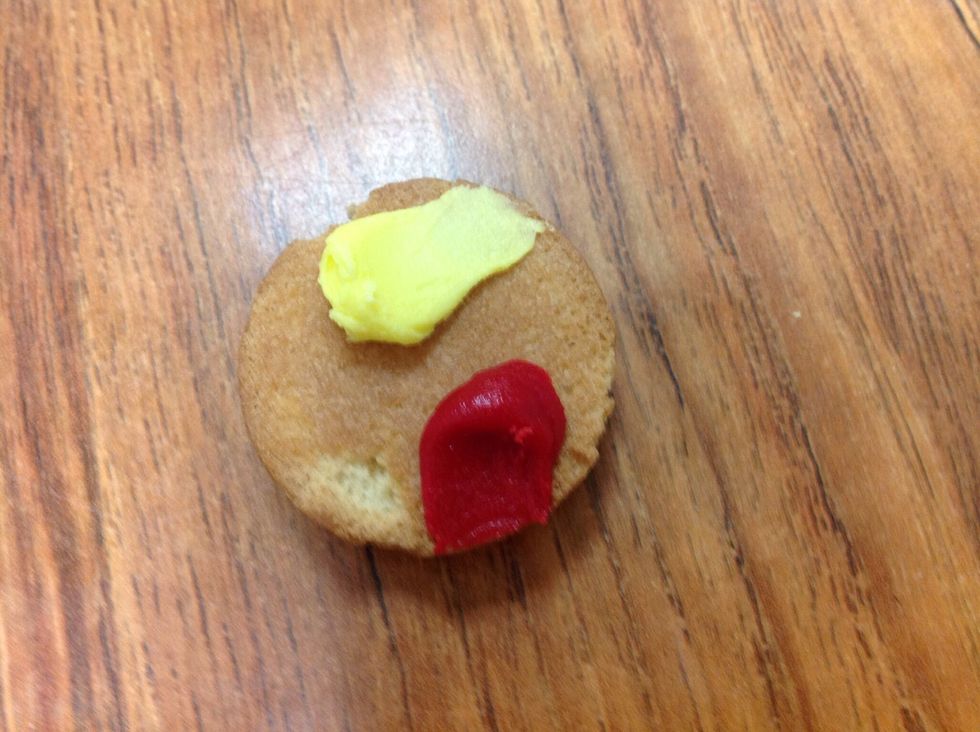 Put one red frosting dot on top of vanilla wafer  (To look like ketchup)