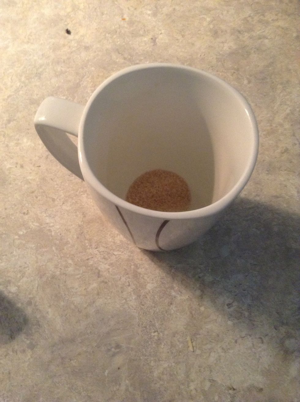 Put one teaspoon of sugar in a mug. (Only if you like your tea with sugar)