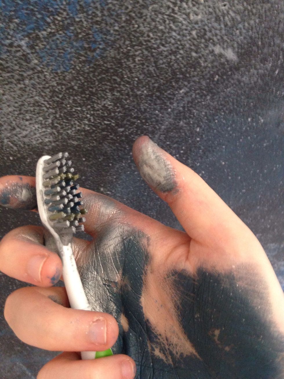 Put paint (white or metallic- your choice) on the toothbrush. Rub your finger on the bristles and flinging the paint on to make stars