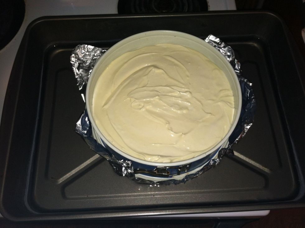 Put pan into middle of large roasting pan. Add about 2 inches of water to pan. This is called a water bath. It helps keep to not crack the top!! Bake at 350* for 1 hr & 15 min DONT OPEN OVEN TILL END