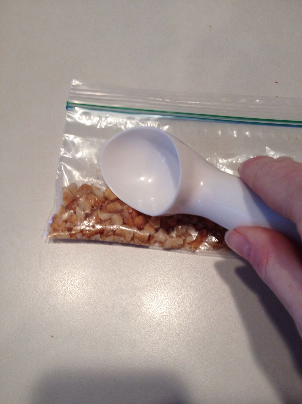 Put peanuts in a ziplock bag and chop with something rigid. Yes, I'm using an ice cream scooper to chop my peanuts. You can laugh - it's kind've funny! :-)