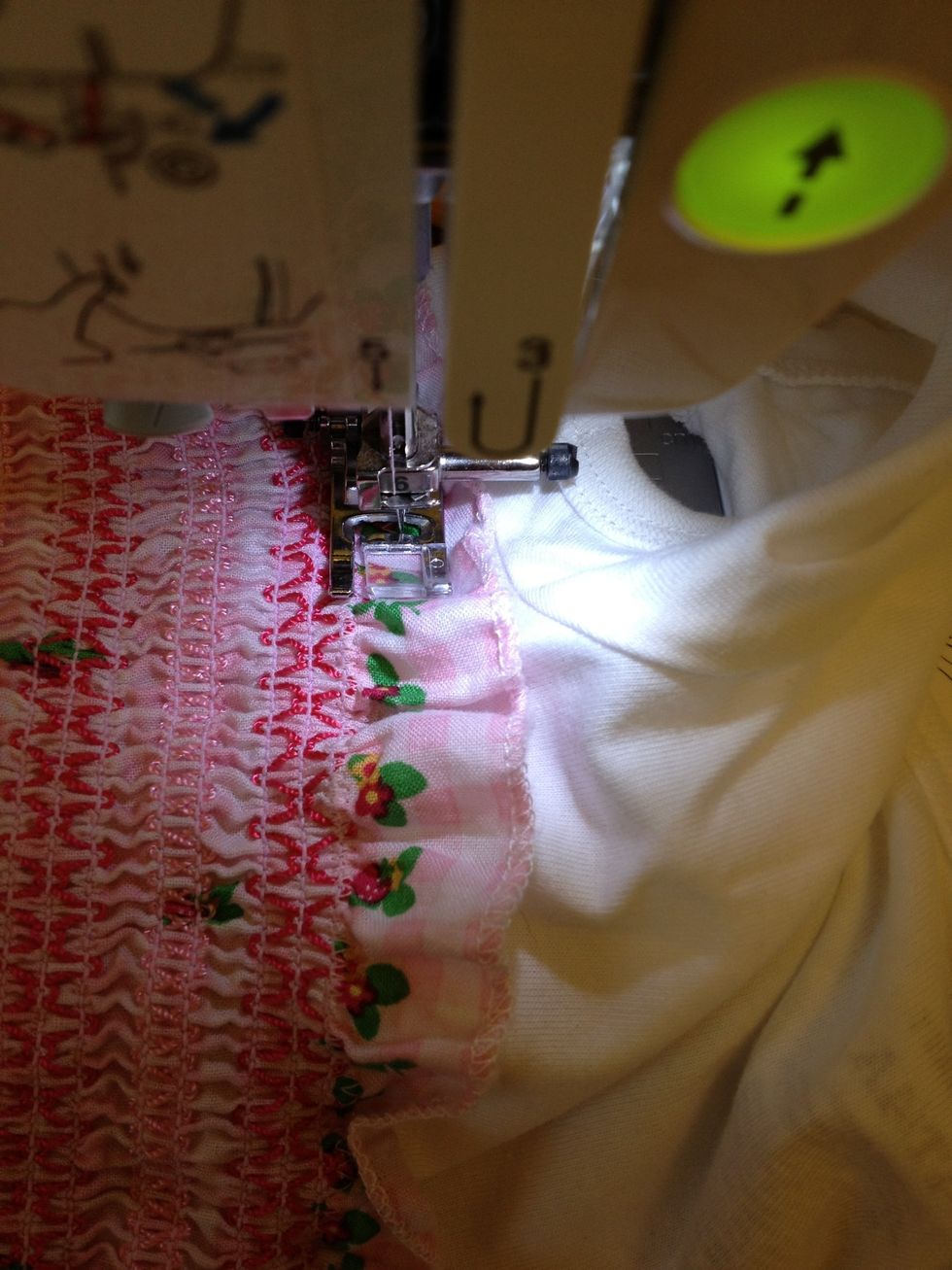 Put pinned dress and shirt on sewing machine through neck hole. See with zigzag stitch and pull dress to make shirt lay flat