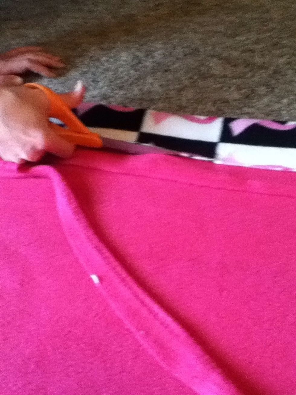 Put pins in both of the other sides to hold the fabric in place. Be careful not to prick your fingers. Trim the excess fabric to make it all unison.