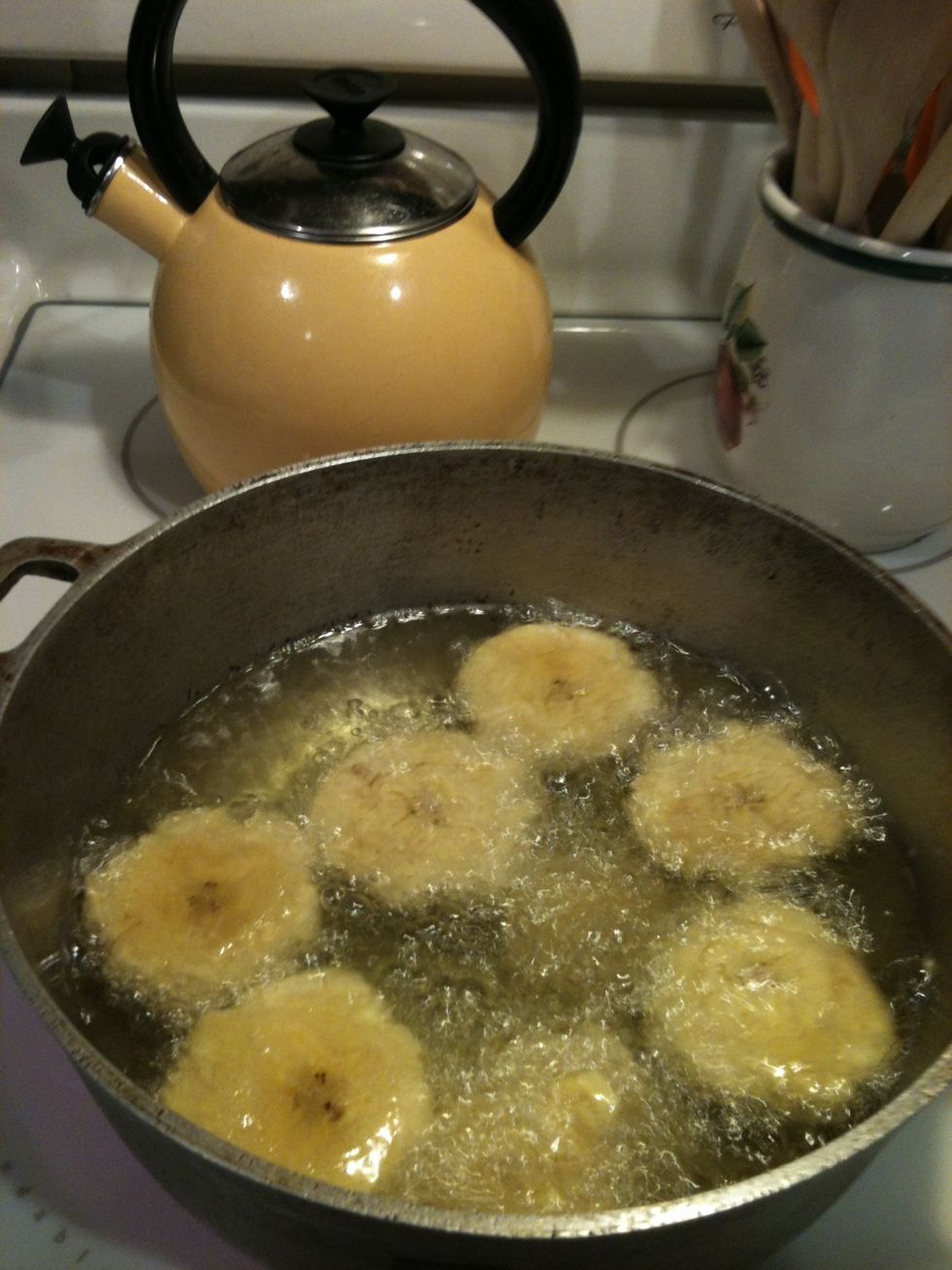 Put plantains back in oil and let them fry again until golden. It should take about one minute.