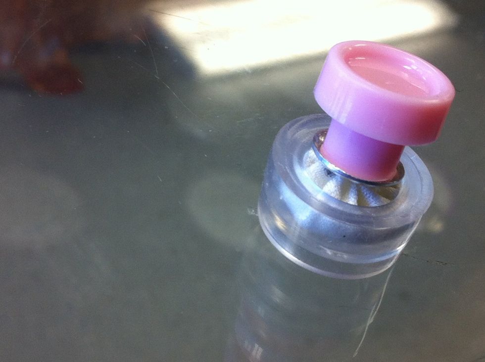 Put plastic part of tool over button back. Make sure fabric edges are still well tucked.