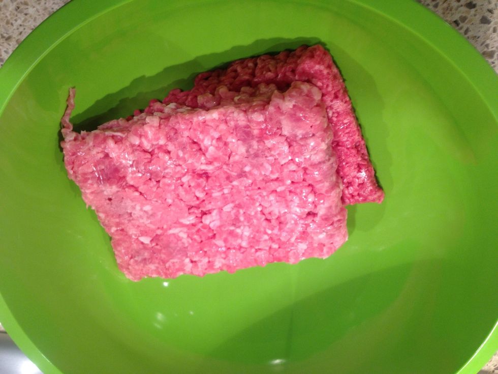Put pork and beef in a large bowl.