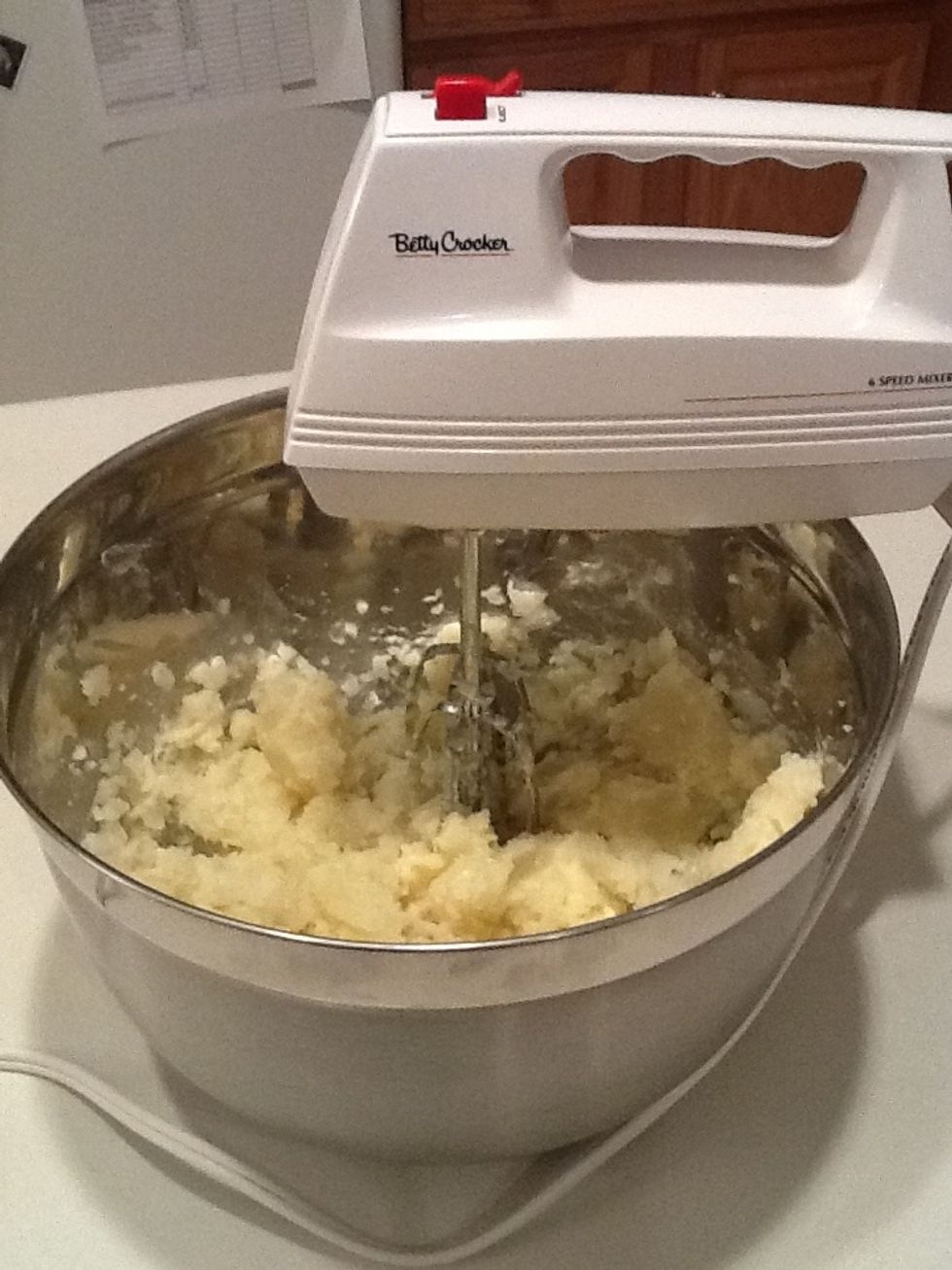 Put potato chunks in a bowl and add the butter. Mix well using a potato masher or a hand mixer as shown.
