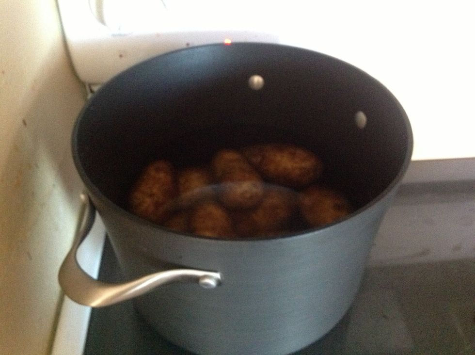 Put potatoes in a pot, cover, and boil. Cook as many potatoes as there is people being served.