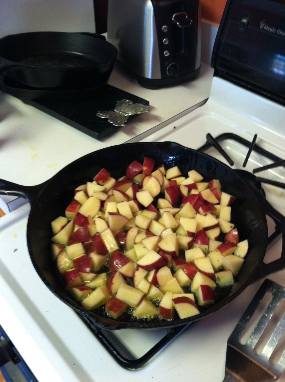Put potatoes in pot and cook until they have browned.
