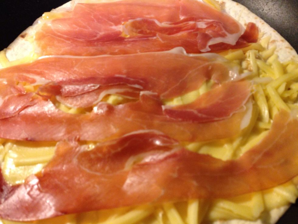 Put prosciutto crudo (parma ham) on top of the cheese