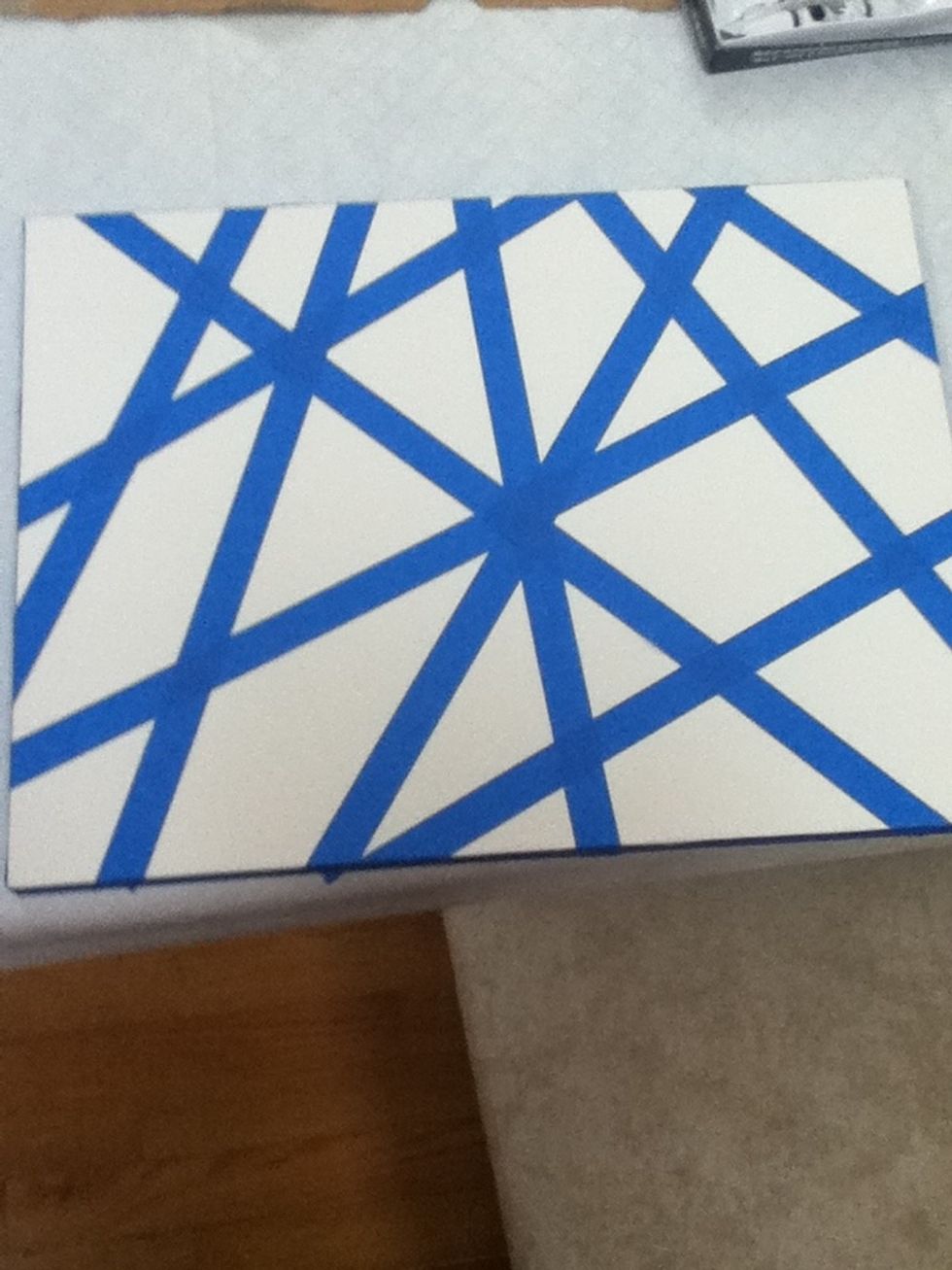 Put random pieces of tape on your canvas. Make sure they go from end to end