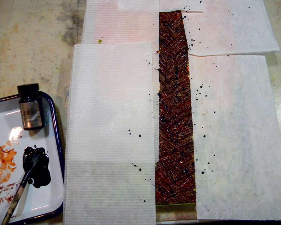 Put scrap paper around the trunk to protect the canvas.  Splatter watered down Tuxedo Black onto the trunk using a fan brush or toothbrush.