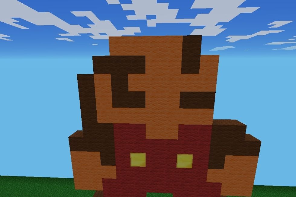 Put sideburns and an eye out of brown wool and finish the face with orange wool