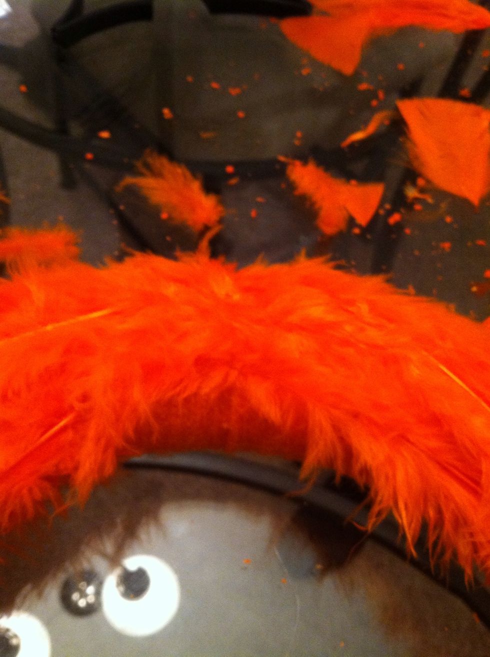 Put small feathers at the top, where the two sides join. This is the face area.