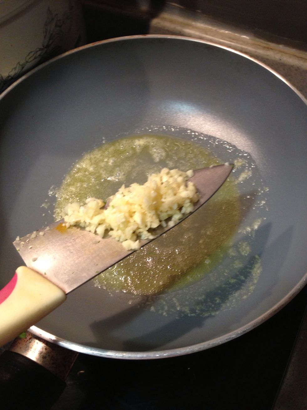 Put some butter in the pan and add mixed garlic in it.