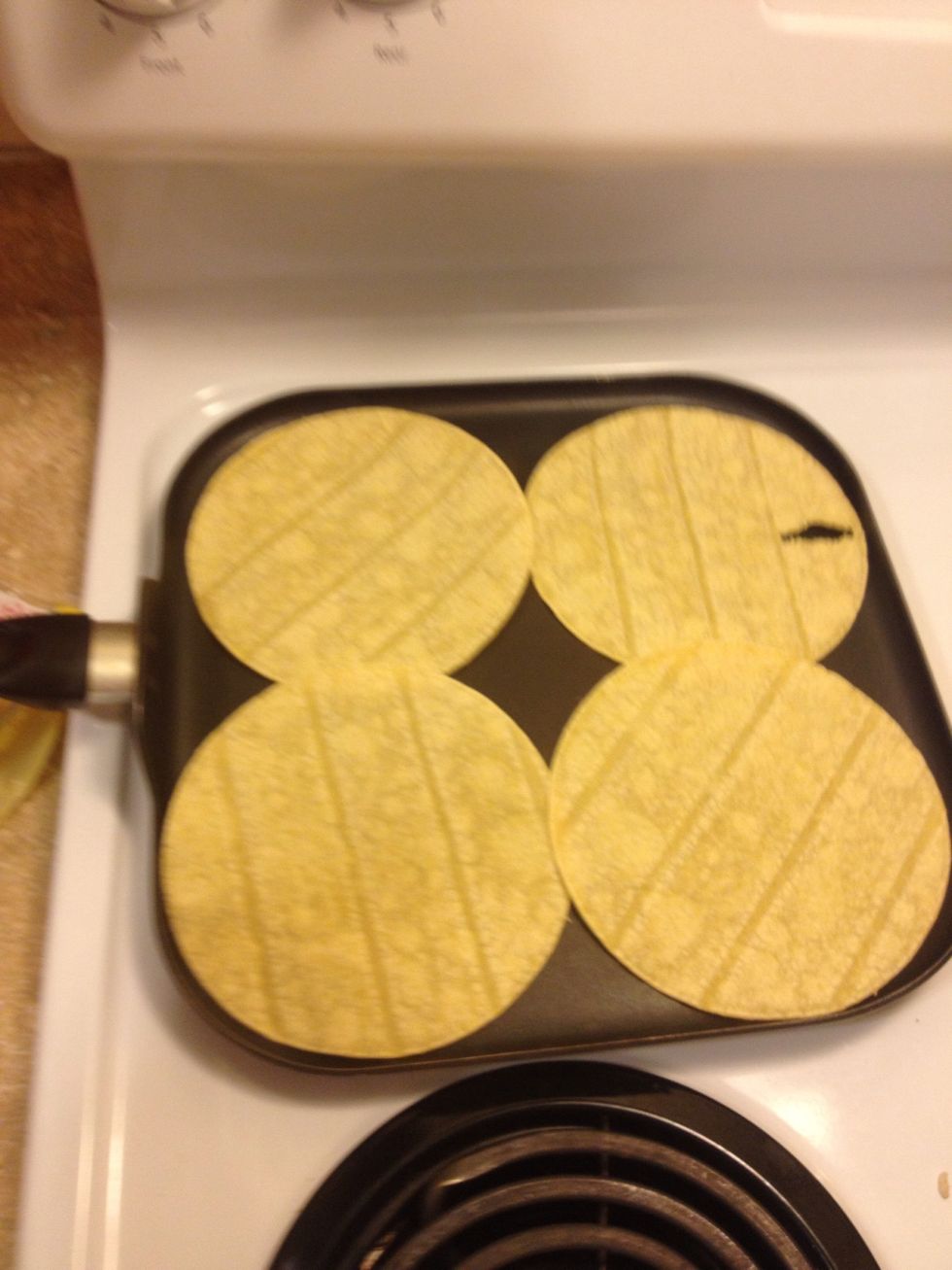 Put some corn tortillas on a pan and brown each side