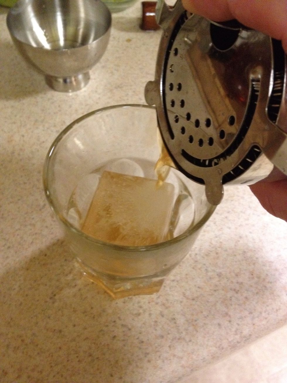Put some fresh ice in your old fashioned glass and strain over the ice. I like to make these big cubes. They melt more slowly and look awesome.