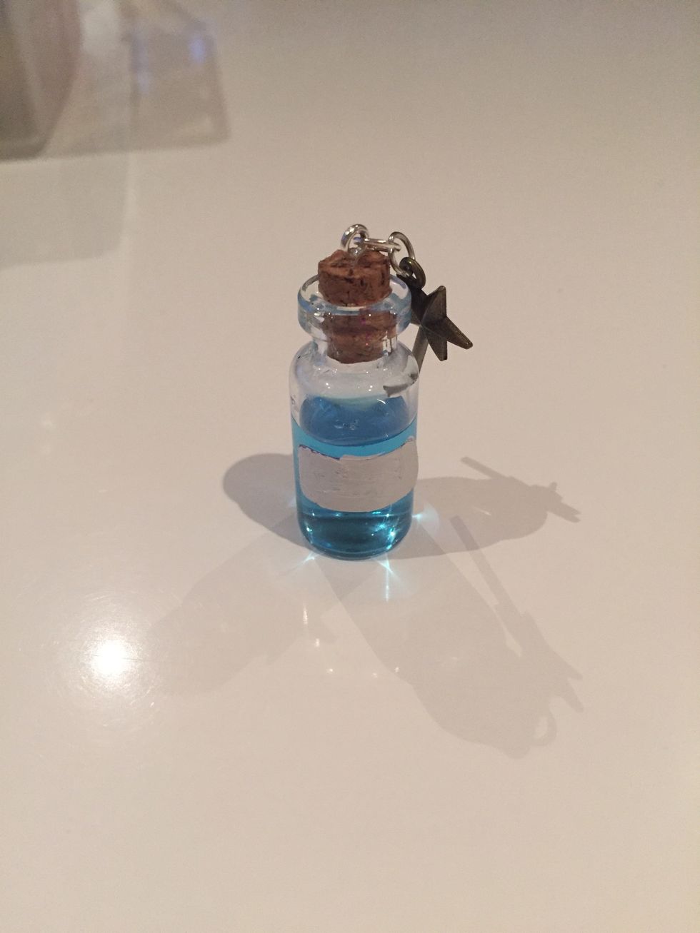 Put some glue on the cork and fit to the top of the bottle. Let this set