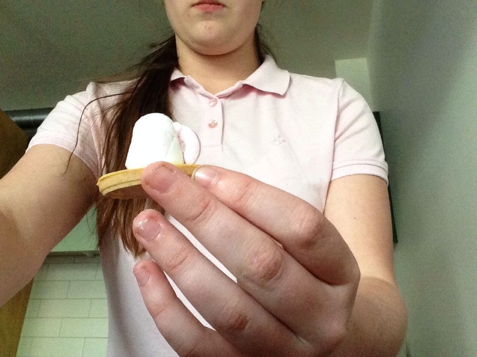 Put some icing on the life saver and stick it to the marshmallow.