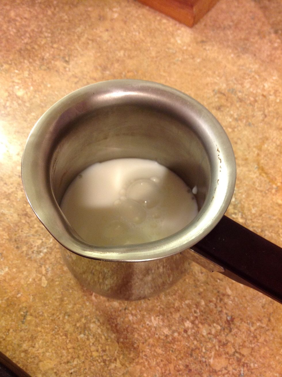 Put some milk in a coffee mug or in a stovetop carafe. (1/3 full) If you want to heat it in the microwave, use the mug. If on the stove, use the metal carafe or a pot. Heat the milk to steaming.
