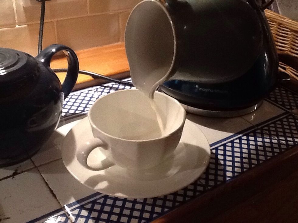 Put some milk into a cup (this is optional.)