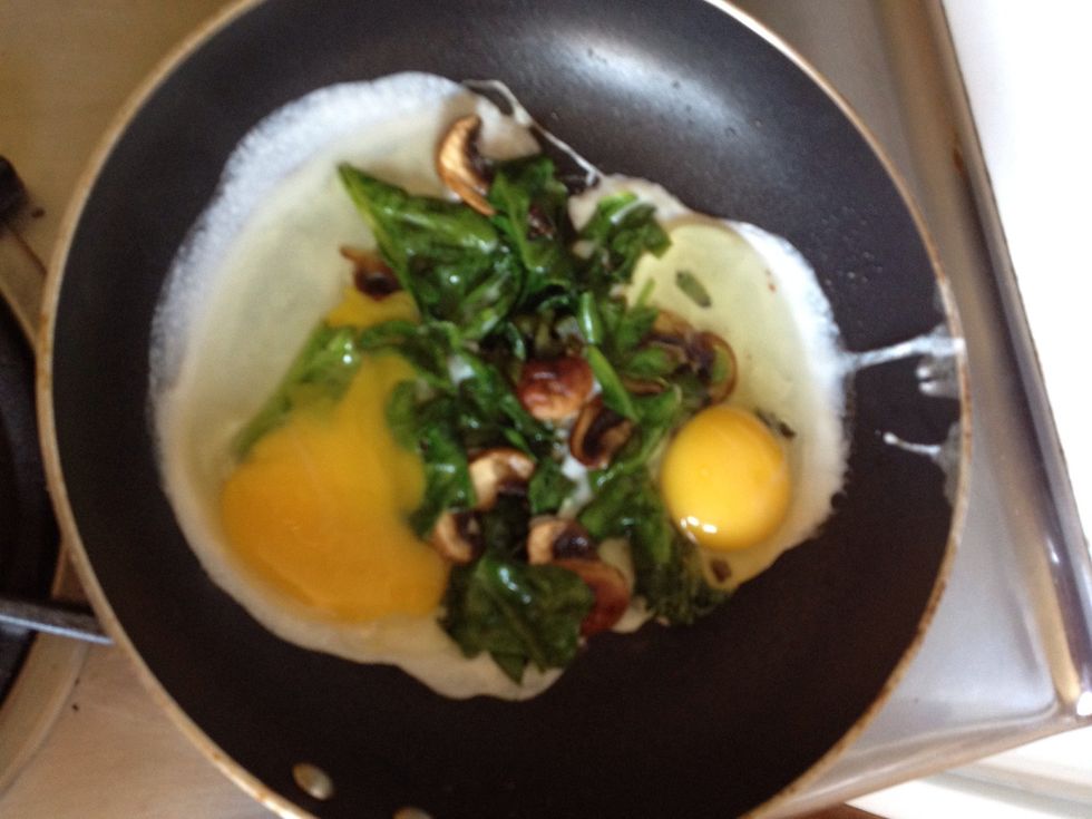 Put some more butter down so the eggs won't stick. Crack eggs over veggies (make sure not to break the yolk like I did!)