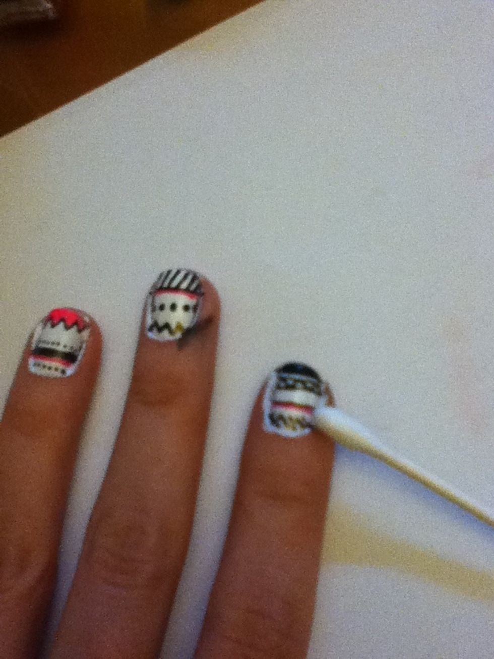 Put some nail polish remover on a Q tip and use it to fix the edges of each nail and fix any mistakes.