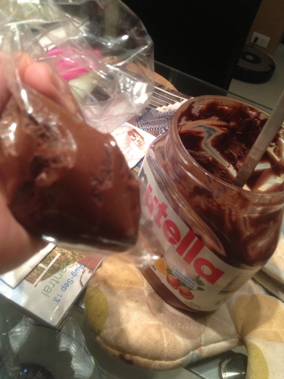 Put some nutella or your fav jam in a piping bag. The Nutella should be cold from the fridge so it's not runny.