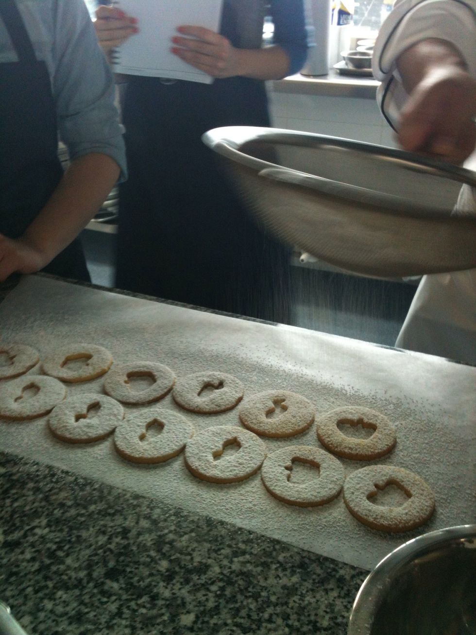 Put some powdered sugar on top of the cookies (the one with the hole)