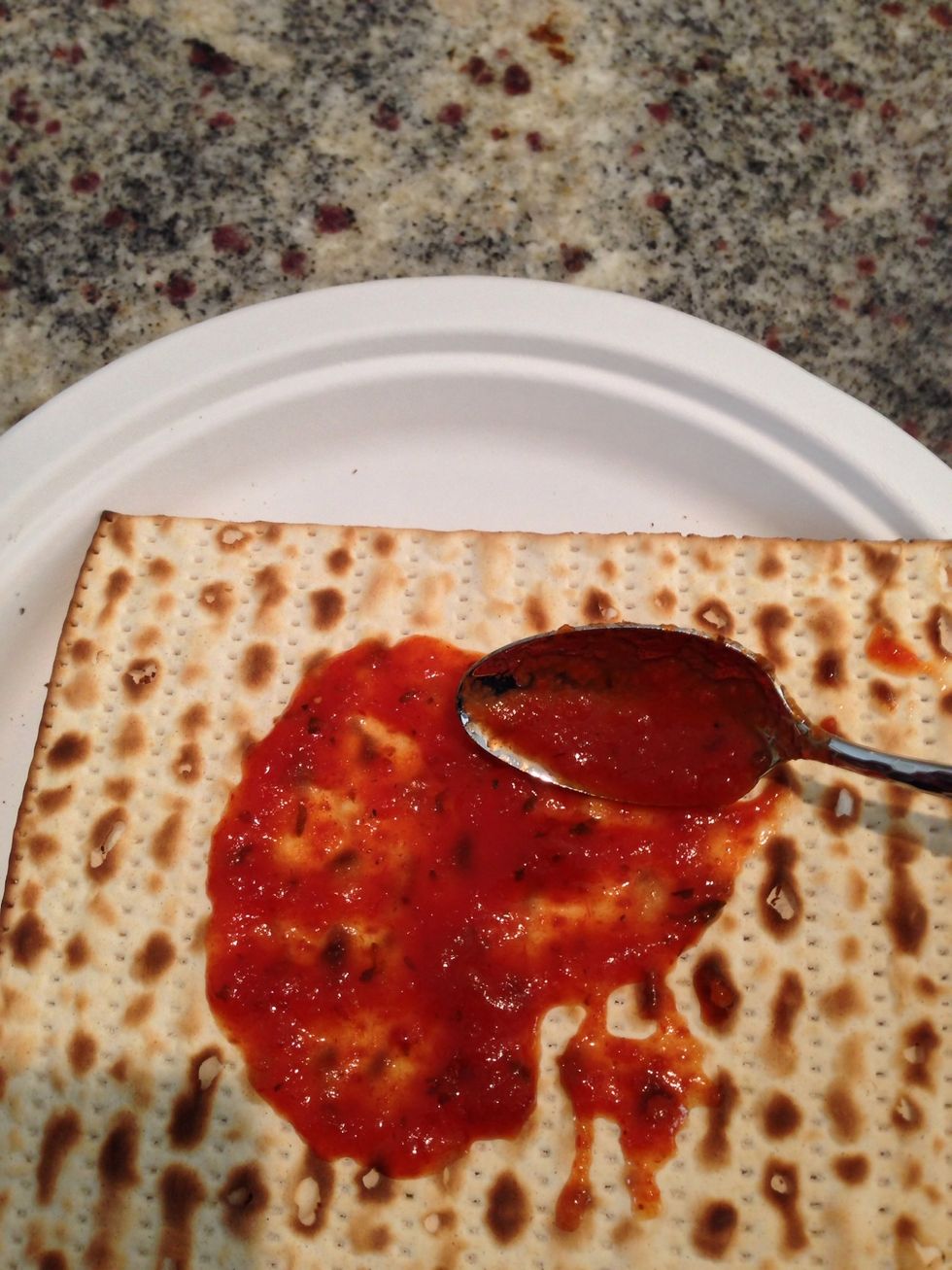 Put some sauce all over the matzah.
