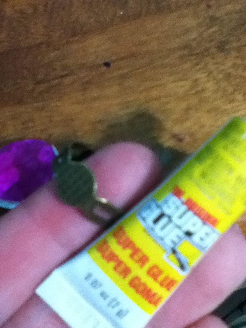 Put some superglue on the ring base and stick it on the glass bead. Hold it on for about a minute so it has time to dry on..use a lot of superglue!