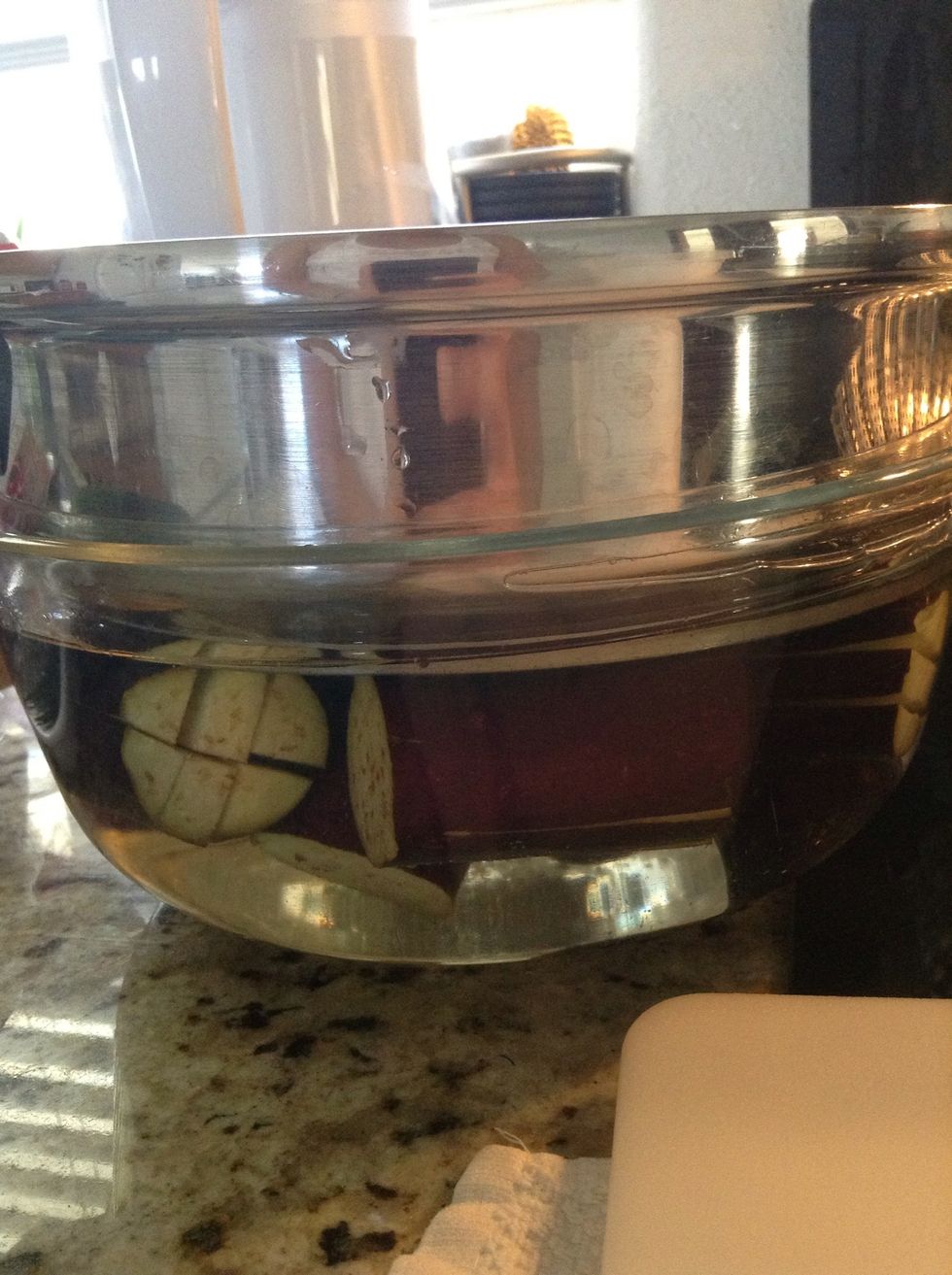 Put something heavy on top to keep the eggplants submerged.