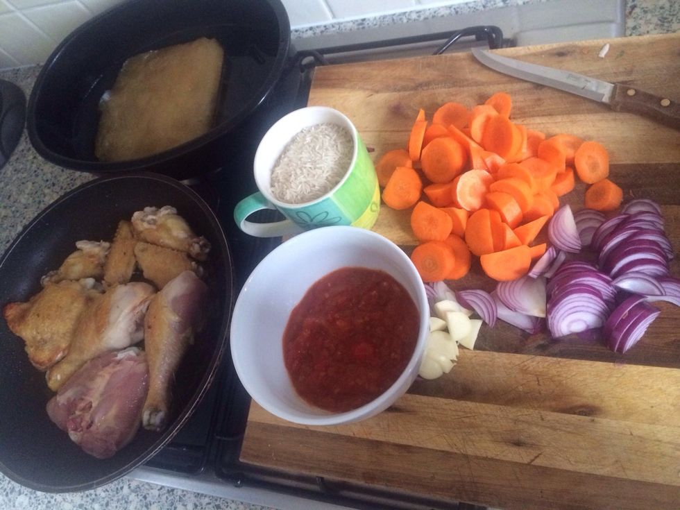 Put stock and tomatoe sauce in oven proof dish and warm through. Chop veg.