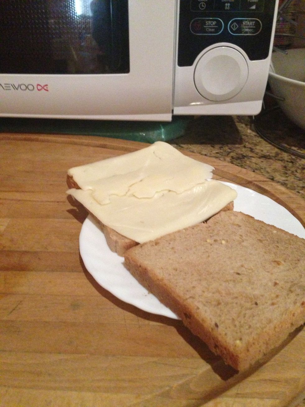 Put swiss cheese over one toast then place that particular one in the microwave for 10 secs