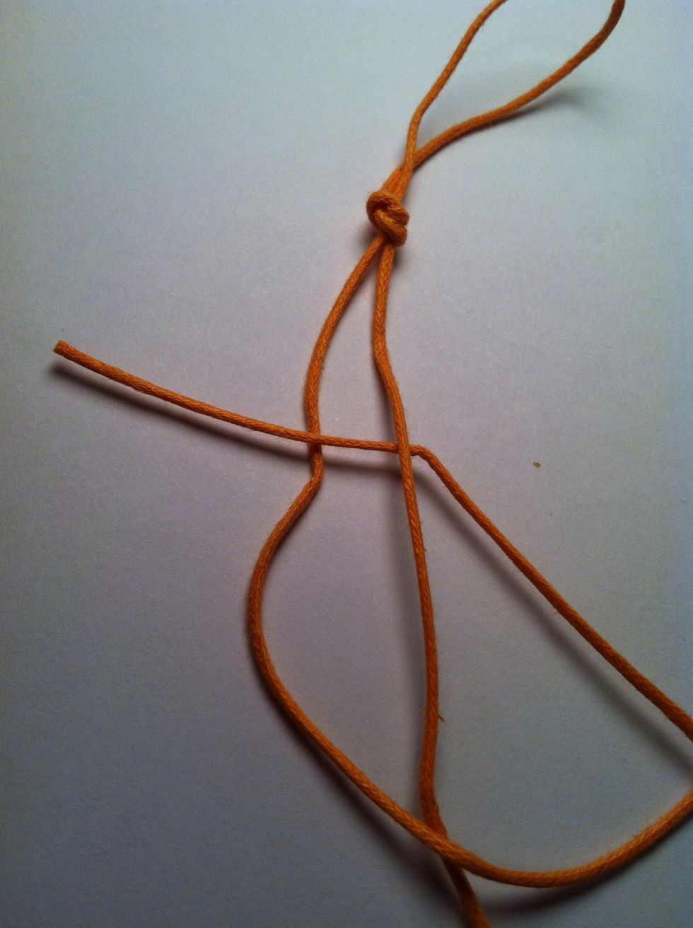 Put tail end under right string and through space.