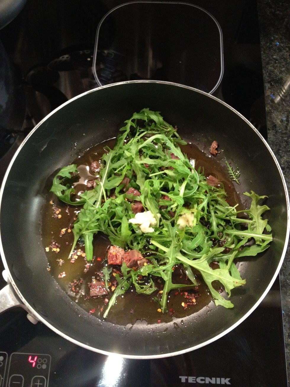 Put the 2 handfuls of Rocket, crushed Garlic, Chilli, Oil and chopped anchovy into a pan and stick on a medium heat and mix/stir occasionally. Your not frying! The oil is part of the sauce.