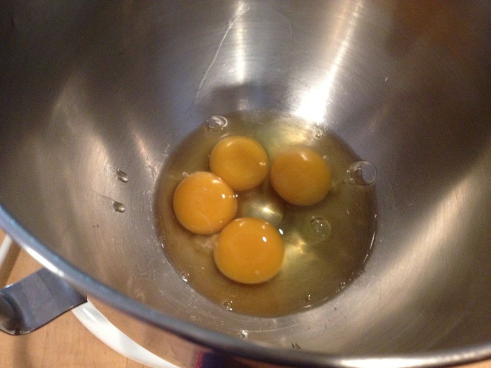 Put the 2 yolks in the bowl of a mixer. Add 2 full eggs.