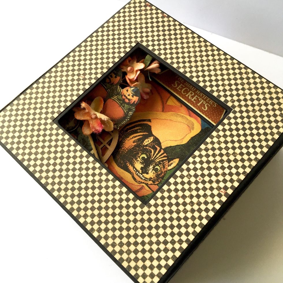 Put the album inside the box.